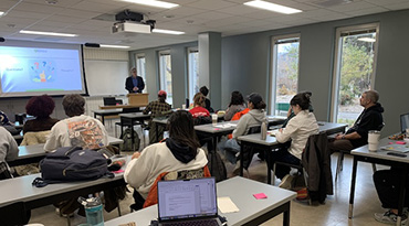 classroom with people looking at instructor at the front of the room