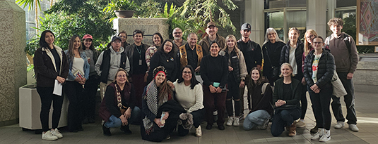 large group of people posing for photo together